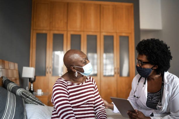 Health visitor and a senior woman during nursing home visit